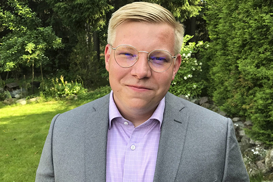 Juho Mäki-Lohiluoma taustallaan kesäistä puustoa.