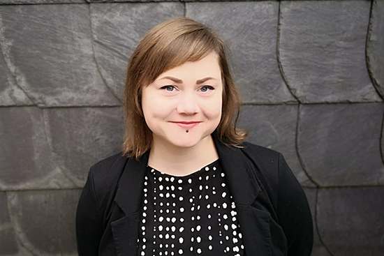 Heidi Schaaf, a stone wall behind of her.