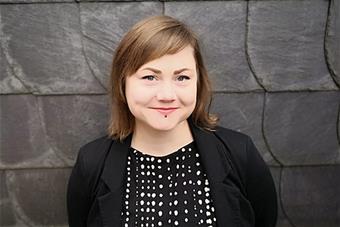 Heidi Schaaf, a stone wall behind of her.